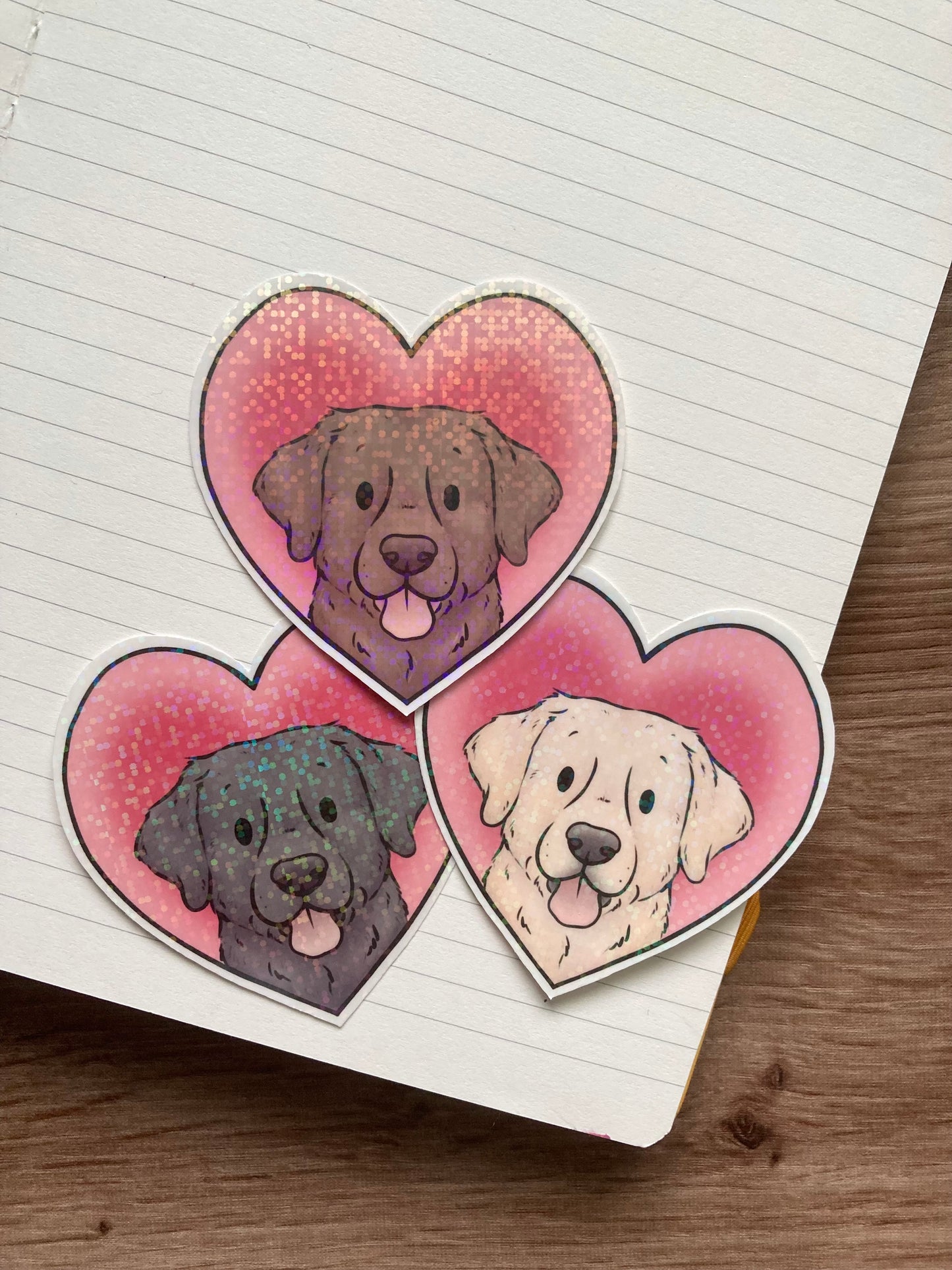 3 Heart-shaped stickers with a dog design on a lined notebook
